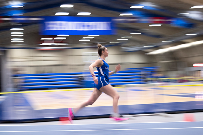athlete running in the indoor track